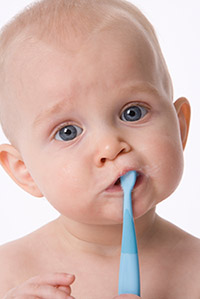 Baby with toothbrush in mouth - Pediatric Dentist in Keller, Fort Worth and Southlake, TX - Bridget McAnthony, DDS