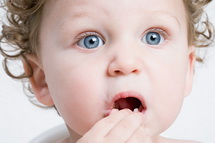 Child holding loose tooth - Pediatric Dentist in Keller, Fort Worth and Southlake, TX - Bridget McAnthony, DDS